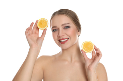 Young woman with cut lemon on white background. Vitamin rich food