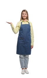 Beautiful young woman in denim apron on white background