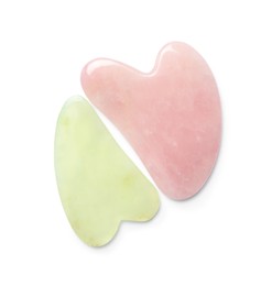 Photo of Jade and rose quartz gua sha tools on white background, top view