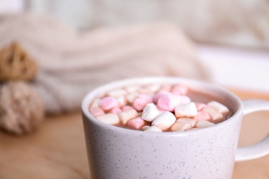 Cup of aromatic cacao with marshmallows on blurred background, closeup. Space for text