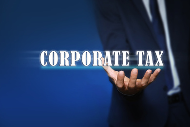 Corporate tax concept. Man on color background, closeup