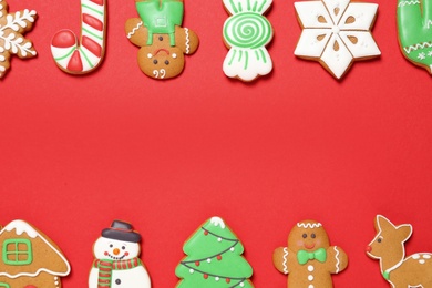 Photo of Different Christmas gingerbread cookies on red background, flat lay. Space for text