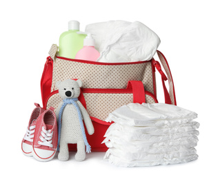 Maternity bag with disposable diapers and child's accessories on white background