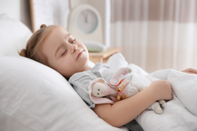 Cute little girl sleeping with toy at home. Bedtime schedule