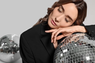Photo of Beautiful woman with disco ball on white background