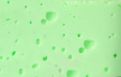 Photo of Closeup view of green slime. Antistress toy