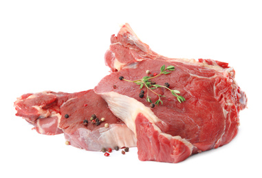 Fresh raw beef cut with thyme and peppers mix isolated on white