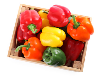 Wooden crate full of fresh ripe colorful bell peppers isolated on white, top view
