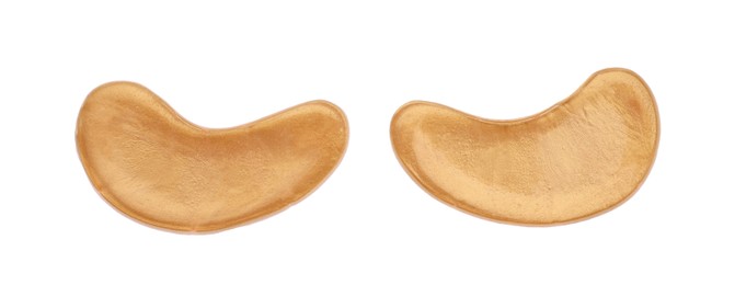 Photo of Golden under eye patches on white background, top view. Cosmetic product