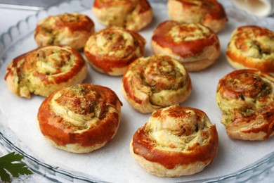 Photo of Fresh delicious puff pastry with tasty filling on tray, closeup