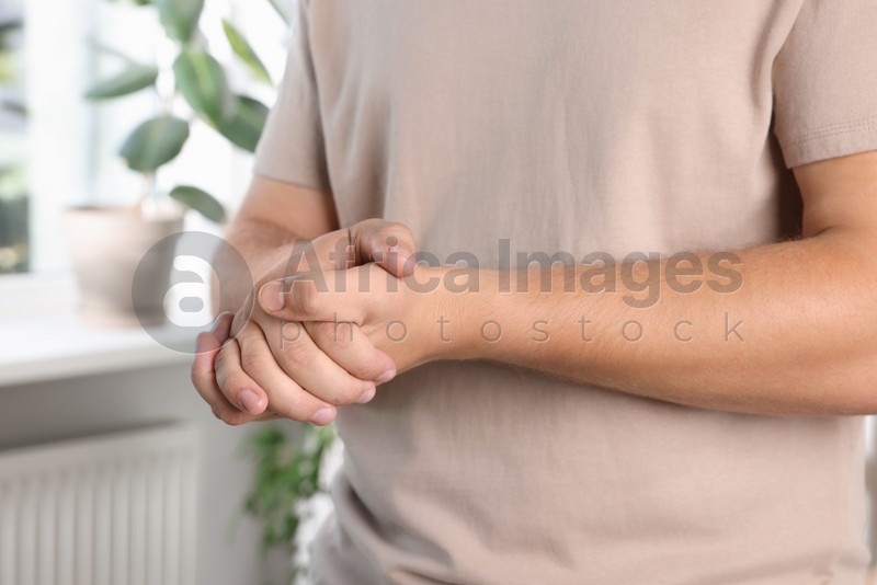 Man applying hand cream at home, closeup
