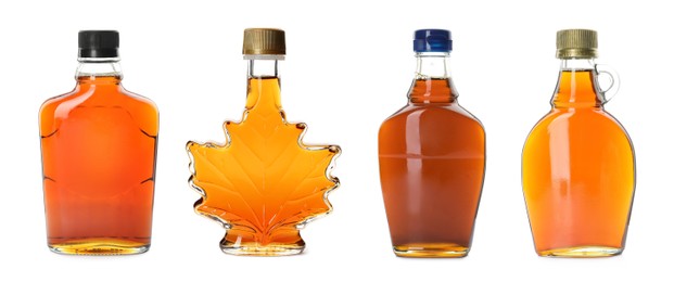 Set with bottles of tasty maple syrup on white background. Banner design