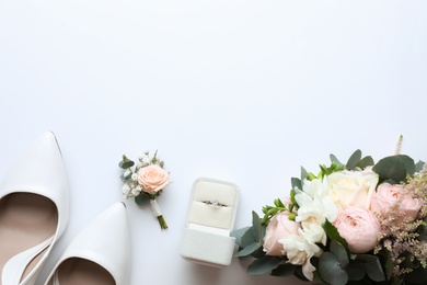 Composition with wedding high heel shoes on white background, top view