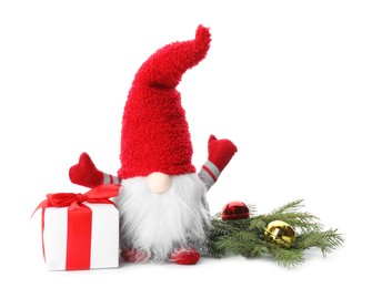 Funny Christmas gnome with gift box and festive decor on white background