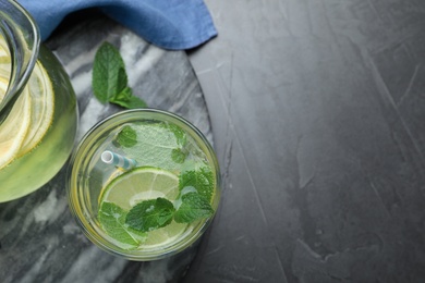 Delicious lemonade made with soda water and fresh mint on grey table, flat lay. Space for text