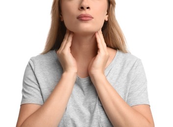 Young woman doing thyroid self examination on white background, closeup