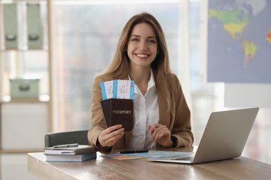 Travel agent with tickets and passports in office