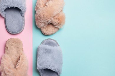 Different soft slippers on color background, flat lay. Space for text