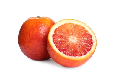 Whole and cut red oranges on white background