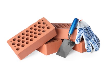 Photo of Pile of red bricks, trowel and gloves on white background