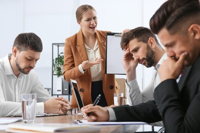 Boss screaming at employees in office. Toxic work environment