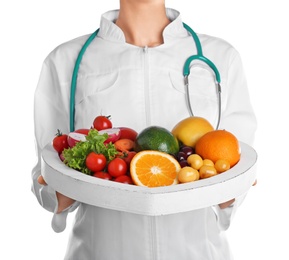 Female doctor with fresh products on white background. Cardiac diet