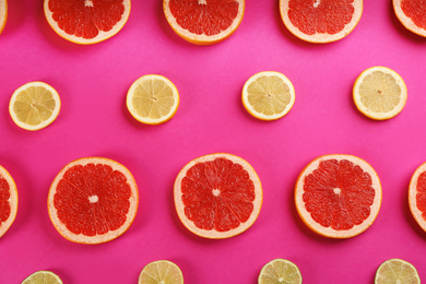 Flat lay composition with tasty ripe grapefruit slices on magenta background