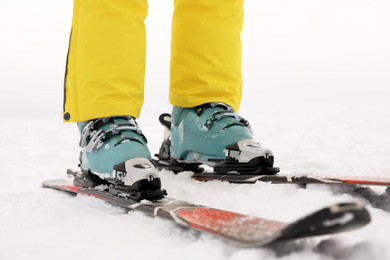 Young woman skiing on snowy hill, closeup. Winter vacation