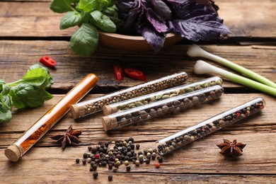 Composition with fragrant spices in glass test tubes on wooden table
