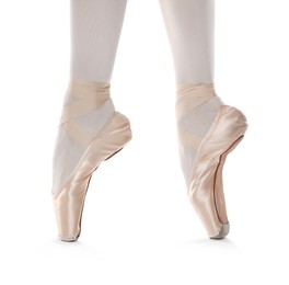 Photo of Ballerina in pointe shoes dancing on white background, closeup