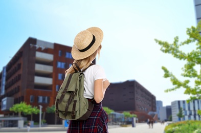 Traveler with backpack in foreign city during summer vacation