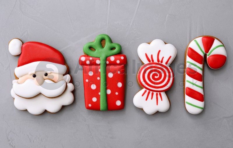 Different Christmas gingerbread cookies on grey background, flat lay