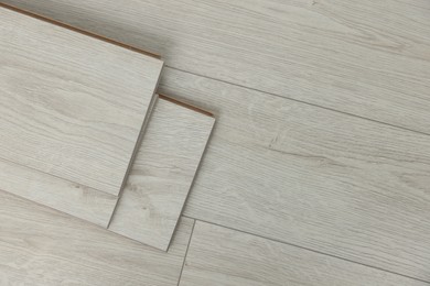 Photo of Parquet planks on floor in room prepared for renovation, top view