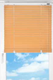Image of Window with modern orange blinds, closeup view