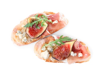 Sandwiches with ripe figs and prosciutto on white background, top view