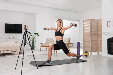 Photo of Fitness trainer recording online classes at home
