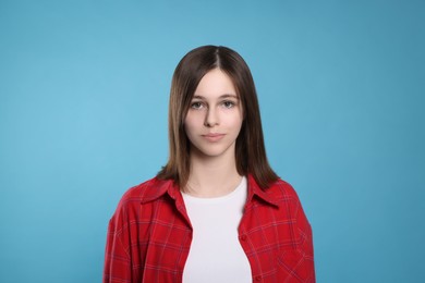 Photo of Portrait of teenage girl on light blue background