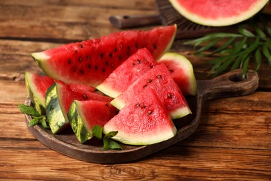 Slices of delicious ripe watermelon on wooden table