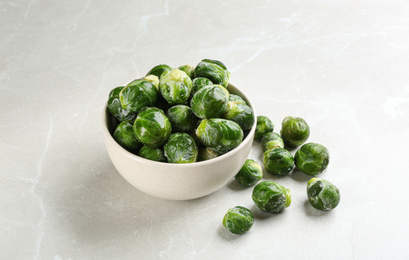 Frozen Brussels sprouts on light grey marble table. Vegetable preservation