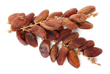 Sweet dates on branches against white background, top view. Dried fruit as healthy snack