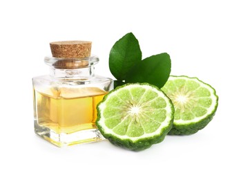 Bottle of essential oil, fresh bergamot fruit and leaves on white background