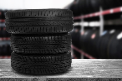 Car tires on grey stone surface in auto store