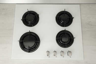 Photo of Modern built-in gas cooktop, top view. Kitchen appliance