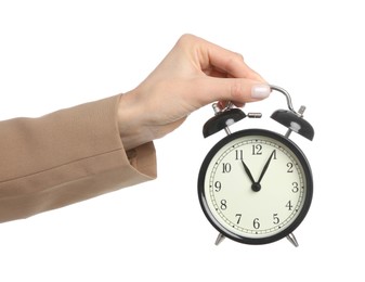 Businesswoman holding alarm clock on white background, closeup. Time management