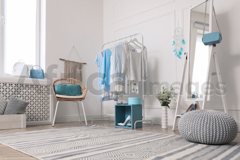 Dressing room with stylish clothes, shoes and accessories. Elegant interior design