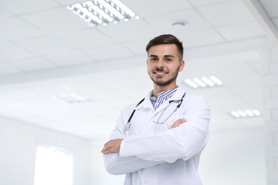 Portrait of male doctor in coat at workplace