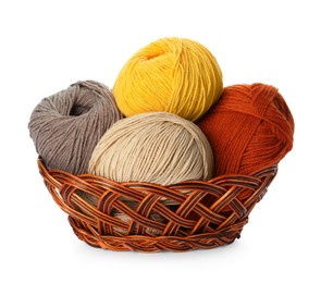 Photo of Different balls of woolen knitting yarns in wicker basket on white background