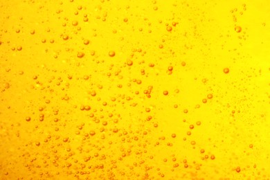 Tasty beer with bubbles as background, closeup