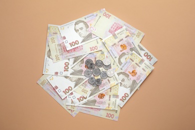Ukrainian money on beige background, flat lay
