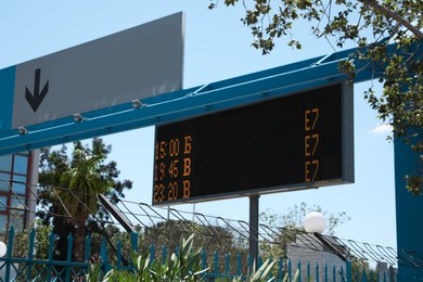 Direction sign and arrival board on city street